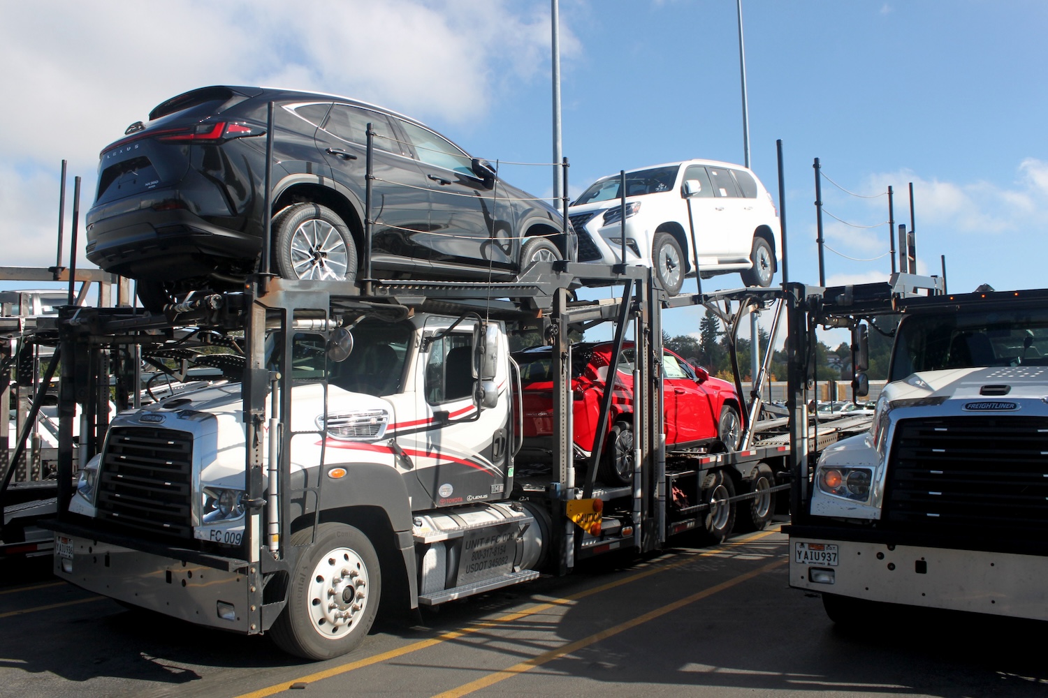 Toyota and Lexus vehicles being loaded onto an auto-hauler trailer