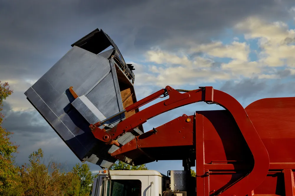 Front-end loader lifting a commercial container